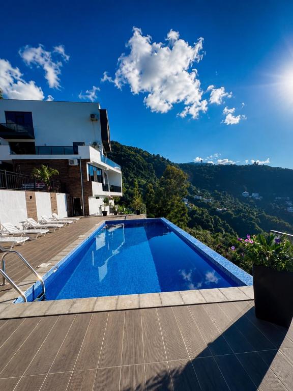 a swimming pool on the roof of a house at Villa Deluxe Kvariati in Kvariati