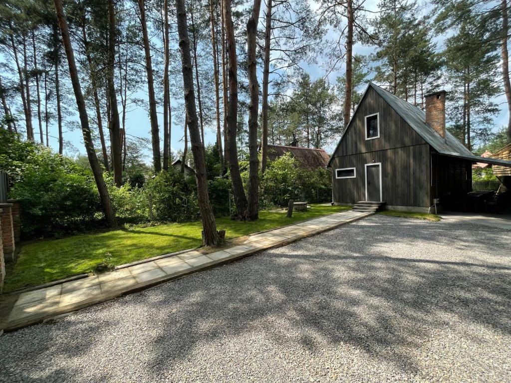 a barn style house with a driveway at Rodzinne Zacisze in Radawa