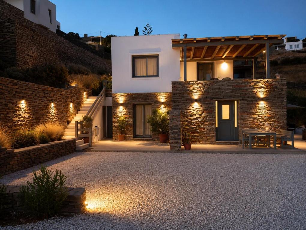 a stone house with lights in front of it at Our Kea apartment in Otziás