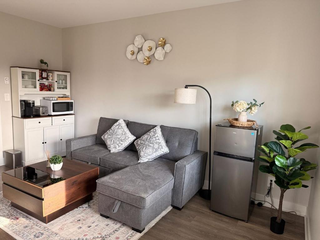a living room with a couch and a table at Guest Suite in Langford in Goldstream Station
