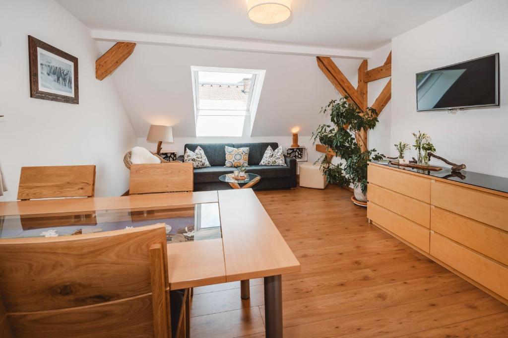 a living room with a table and a couch at Haus Auszeit in Rauris