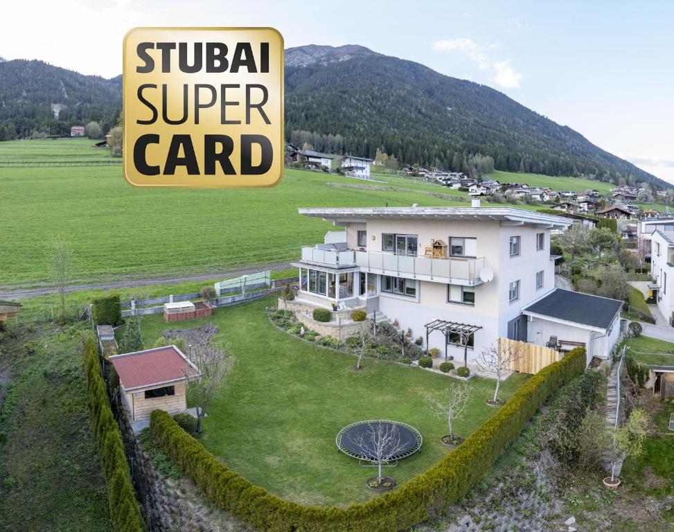 a house with a sign that reads stupid super card at Ferienwohnung Bergsonne in Telfes im Stubai