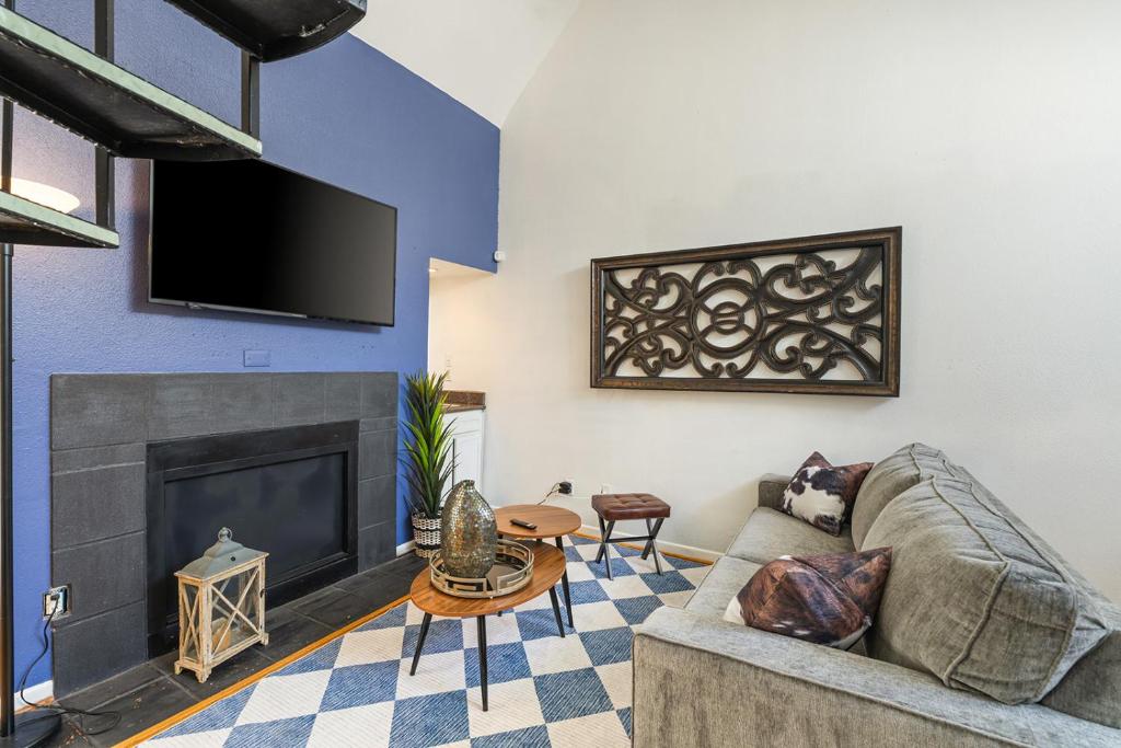 a living room with a couch and a fireplace at Austin Apartments by Andes STR in Austin