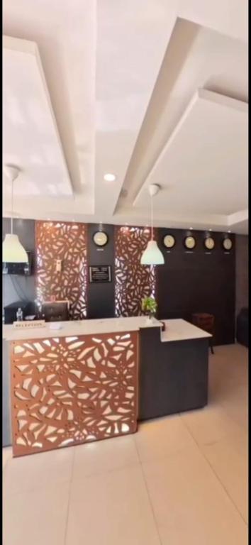 a kitchen with a counter with a wooden wall at HOTEL MEREDIAN GRAND INn in Shamshabad