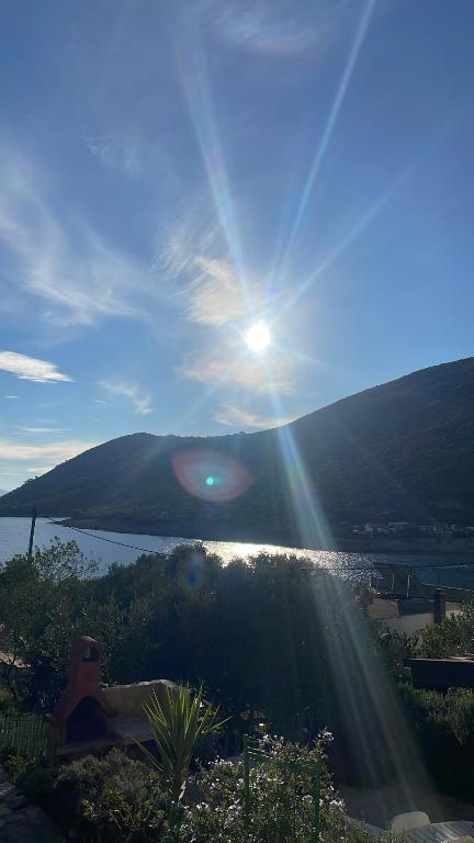 a sun shining on a hill with a body of water at Hvar-Zarace Ina 2 in Gdinj