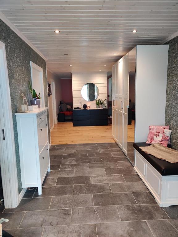 a living room with a couch and a tile floor at Ulriksdal in Ulriksdal
