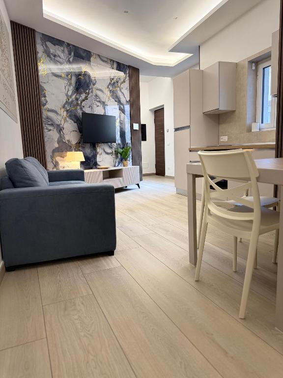 a living room with a couch and a table at Cagrovi Apartments in Casoria