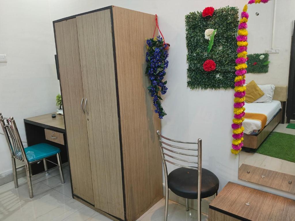 a room with a cabinet and a bed and a chair at Hotel Dream Rooms- Friendly Rooms in Salt Lake City