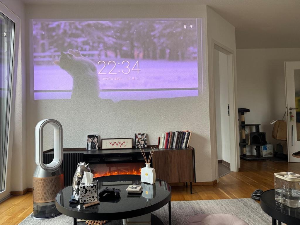 a living room with a large projection screen at Ori's apartment in Frankfurt
