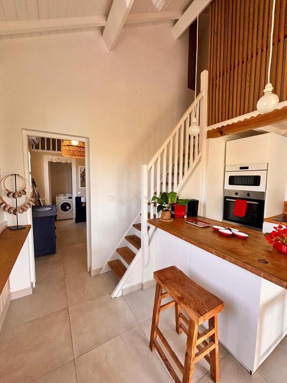 a kitchen with a counter and a staircase in a room at Orient Bay charming in Saint Martin