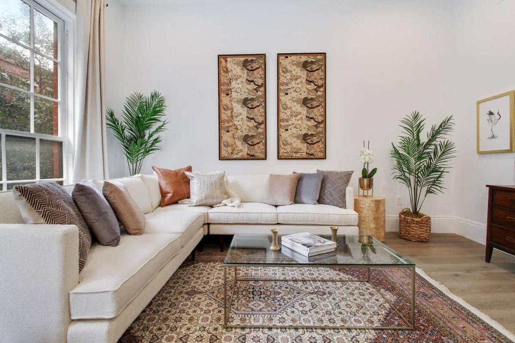 a living room with a white couch and a glass table at Luxe 8BR CBD Duplex Private Courtyard in New Orleans