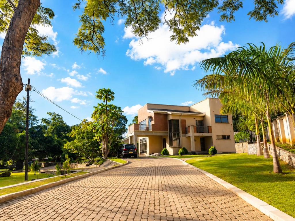 a cobblestone street in front of a house at JAC Tilama BNB Villa-3 Bedroom in Blantyre