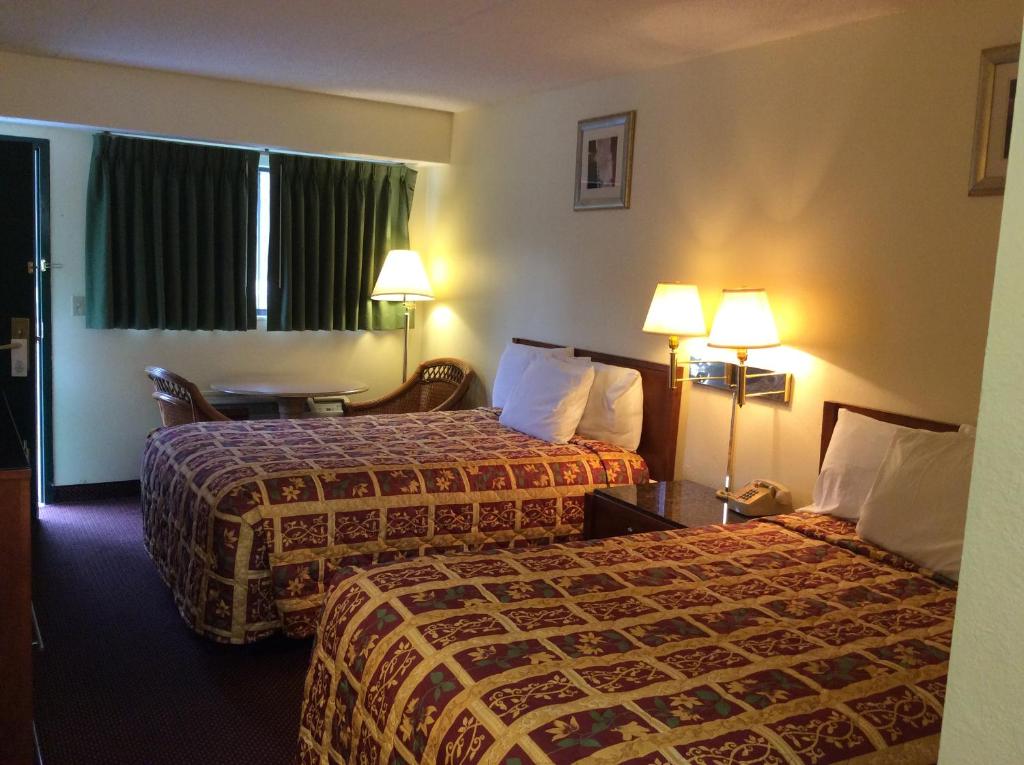 Habitación de hotel con 2 camas y 2 lámparas en Days Inn by Wyndham York Alabama, en York