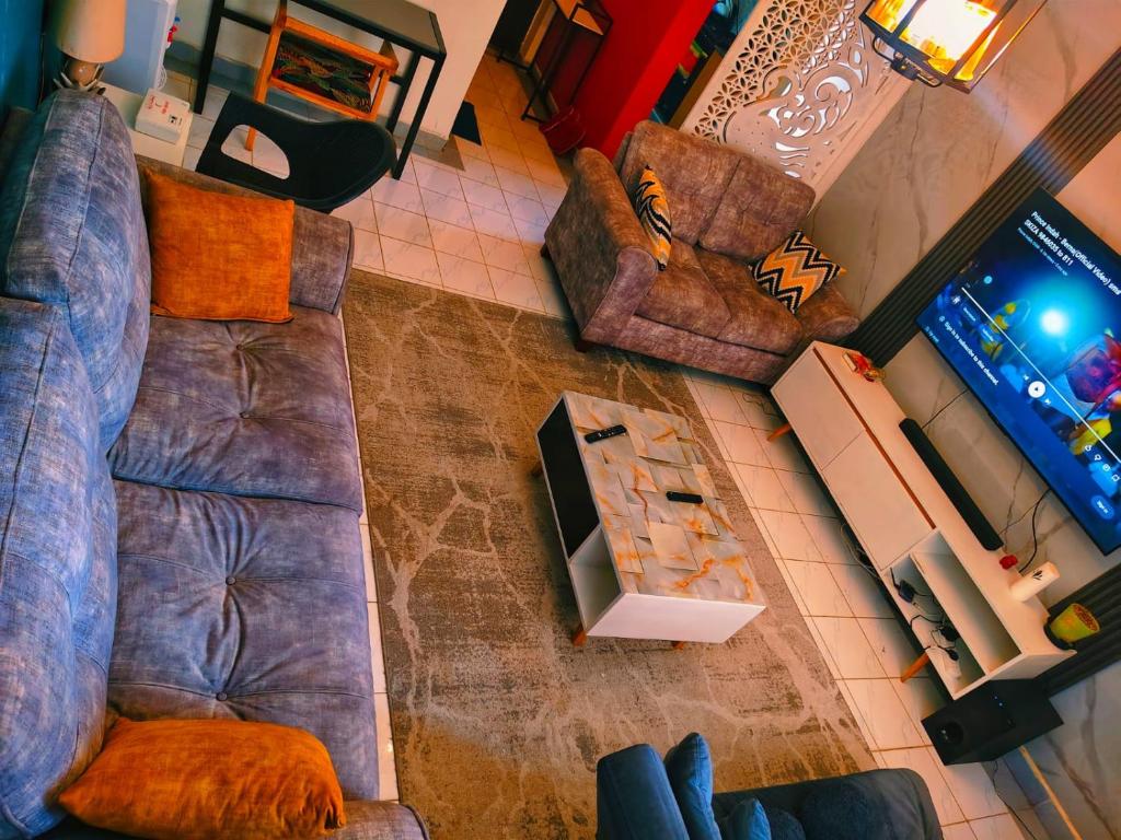 an overhead view of a living room with a couch and chairs at Greatwall Apartment in Syokimau