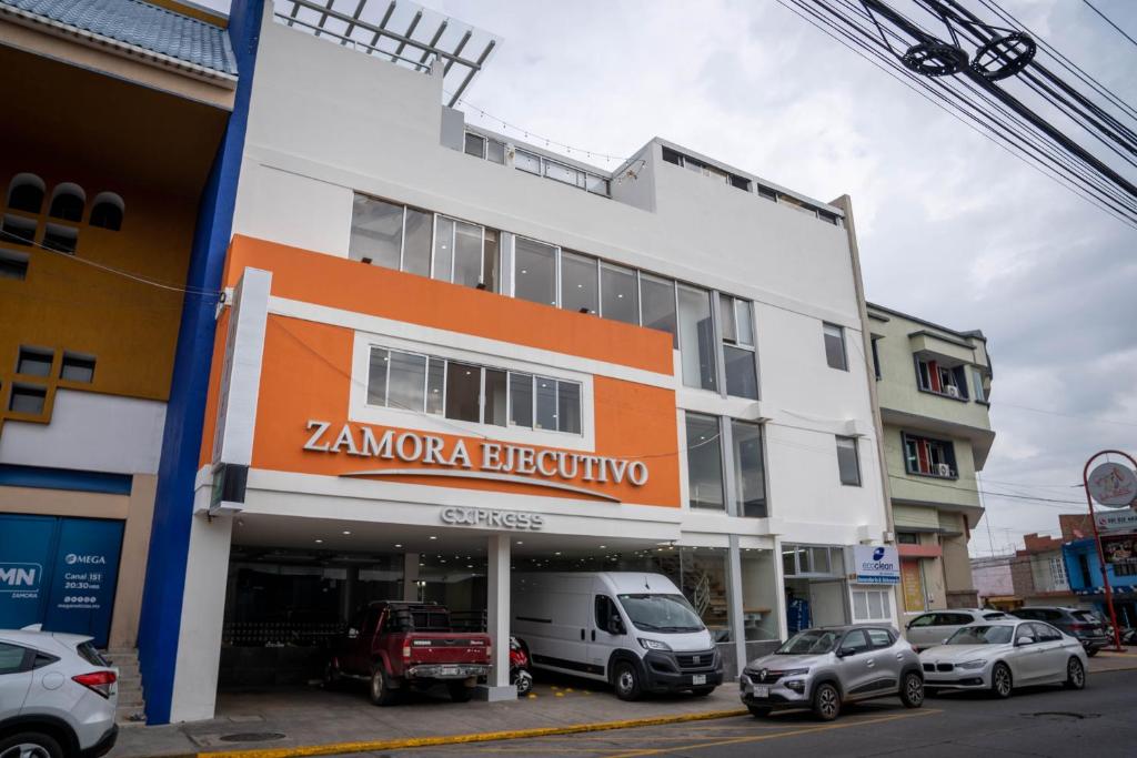 a building with an orange sign on the side of it at ZAMORA EJECUTIVO EXPRESS in Zamora de Hidalgo