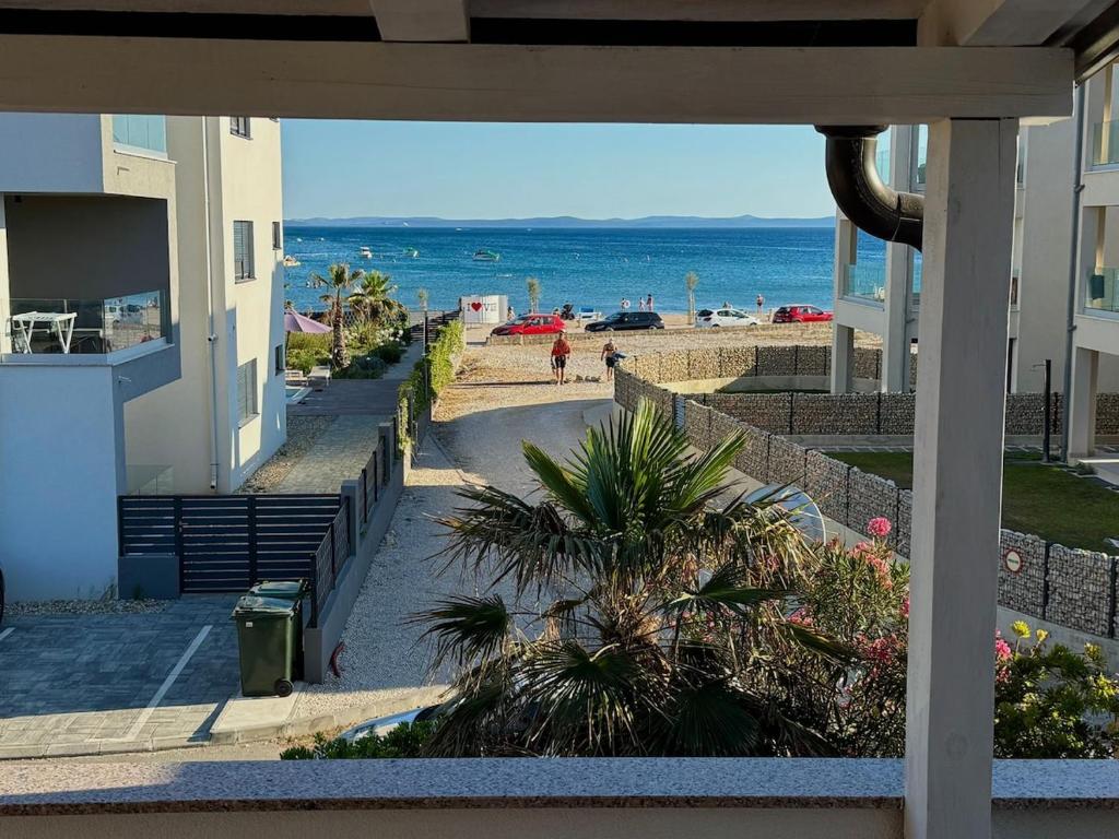 a view of the beach from the balcony of a building at Villa LIR in Vir