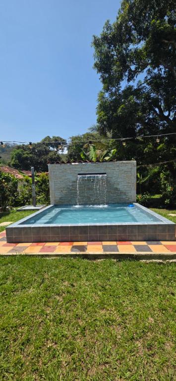 a fountain in the middle of a park at Cabaña Las Lajas la pintada in La Pintada
