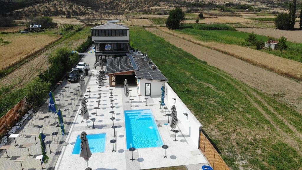 an aerial view of a swimming pool and a building at Bran Apartments in Star Dojran