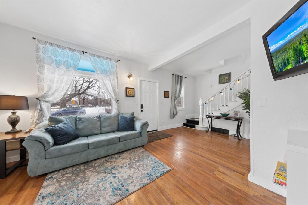 a living room with a couch and a tv at 4BR Home Across from Como Lake - Evergreen in Saint Paul