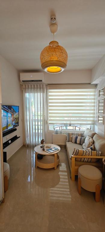 a living room with a couch and a table at VALEXX luxury studio in Perea
