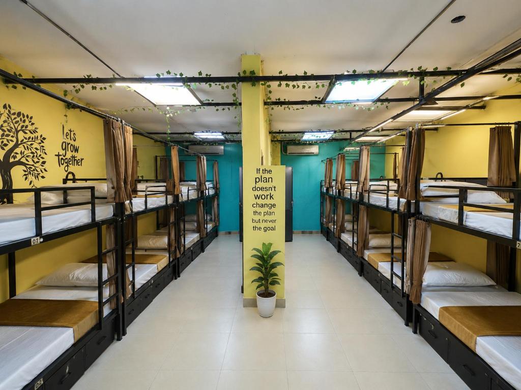 a group of bunk beds in a room with a sign at GPT hostel in Hyderabad