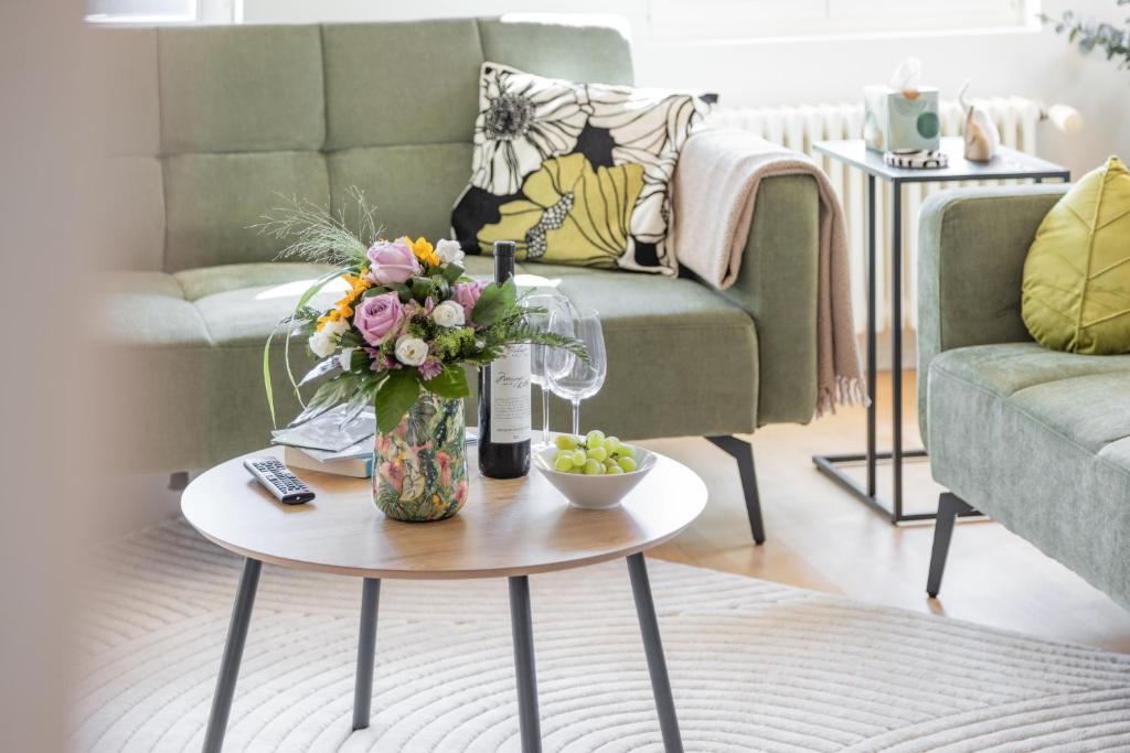 a living room with a vase of flowers on a table at BASEKAMP Prime I Friends I Lake I Mountains I Luzern in Küssnacht