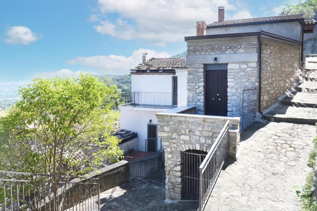 a stone house with a staircase leading up to it at Casa Nora in Valsinni