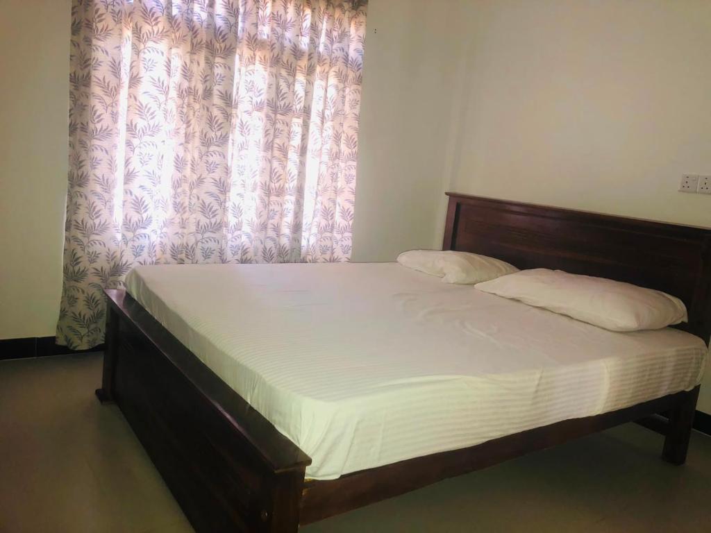 a bed in a room with a window with a mattress at Sanku guest house in Jaffna