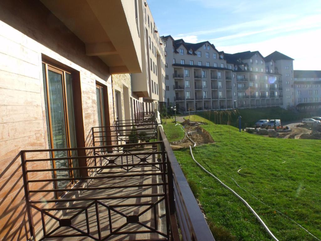 a balcony of a building with a view of a street at Milmari N2 Erdeg in Kopaonik