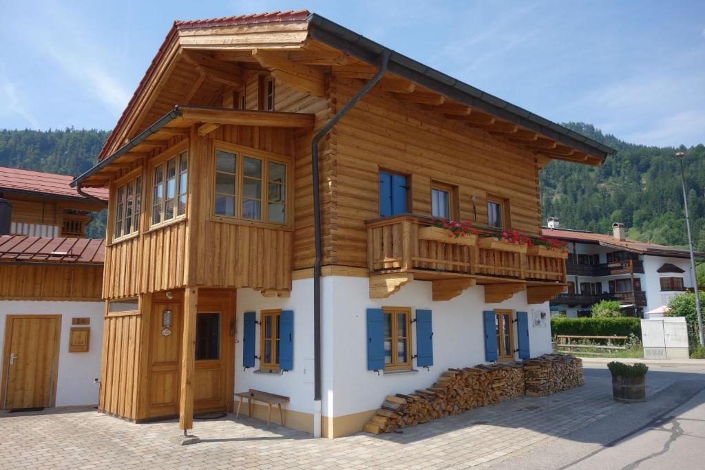 a wooden house with a balcony on top of it at Beim Schlenz in Reit im Winkl