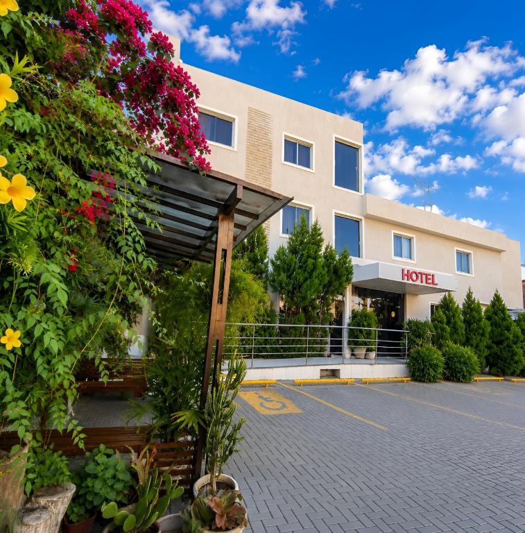 a hotel with a lot of flowers in front of it at Hotel Aeroporto Star in Fortaleza