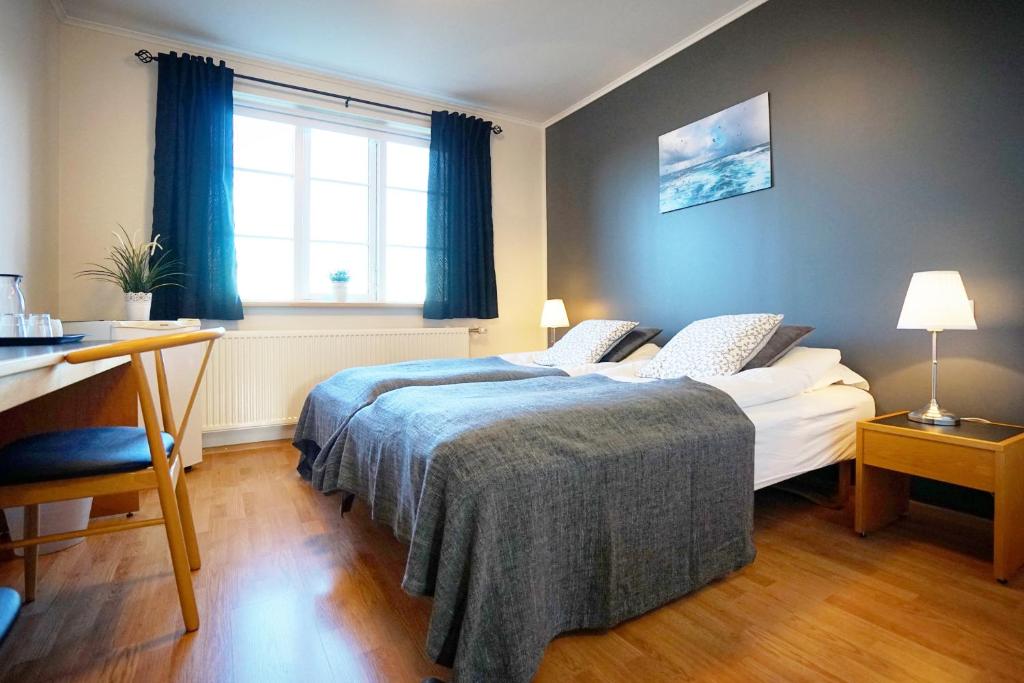 Postel nebo postele na pokoji v ubytování Grenivik Guesthouse