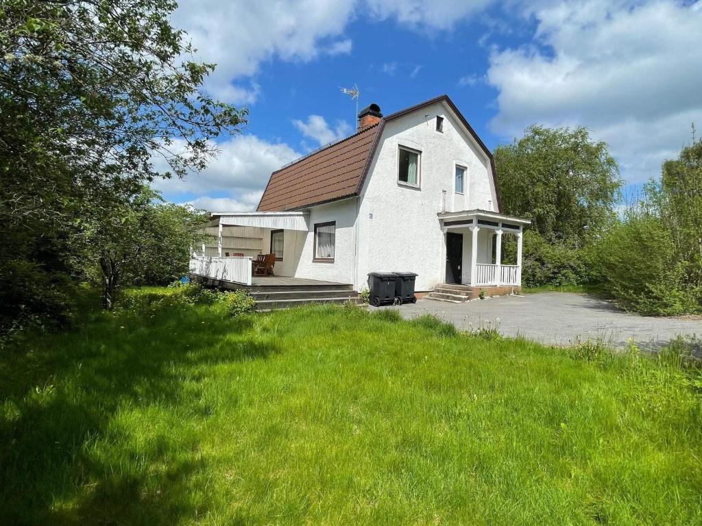 a white house with a red roof and a yard at Holiday Home in Ruda with Terrace in Ruda