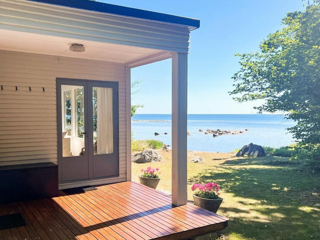 a screened in porch with a view of the ocean at 6 person holiday home in SÖLVESBORG-By Traum in Sölvesborg