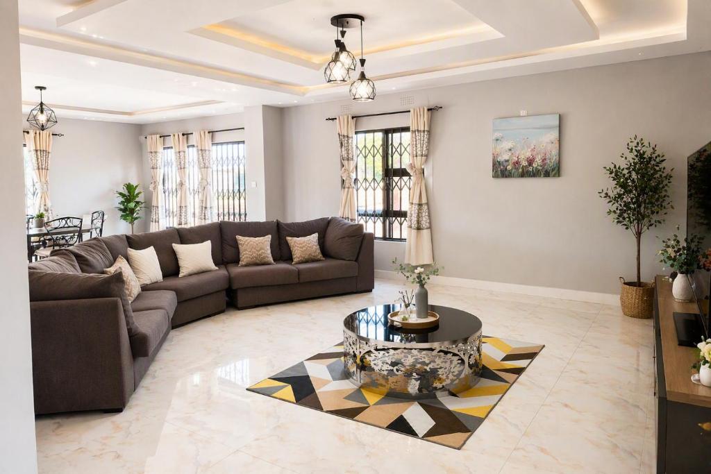 a living room with a couch and a table at Chic Modern Escape in Lusaka