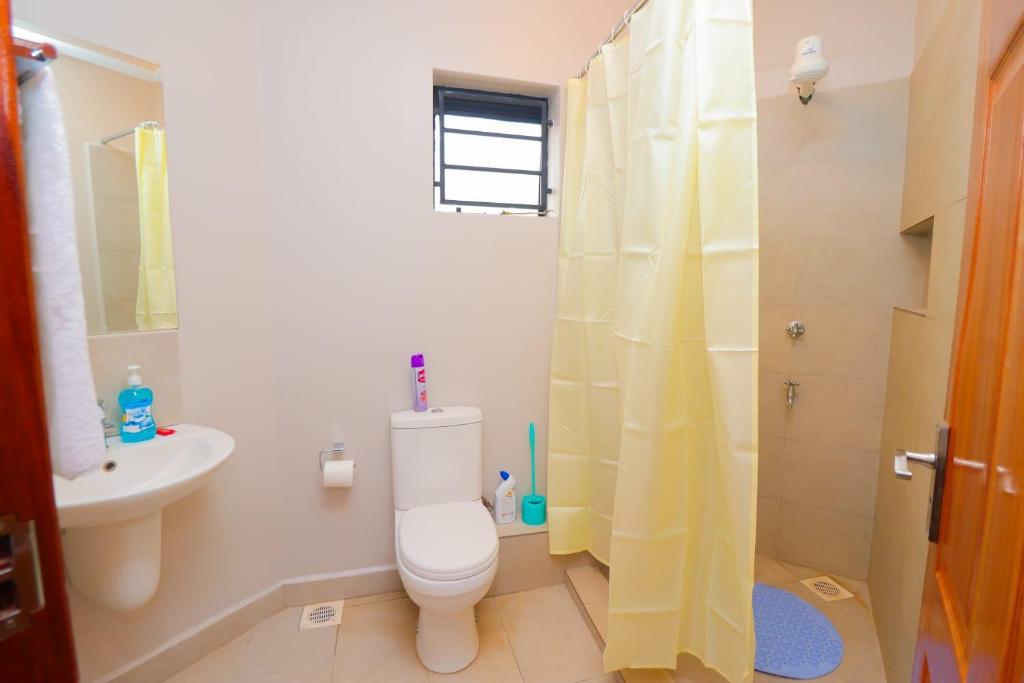 a bathroom with a toilet and a sink at Kasarani trm in Nairobi