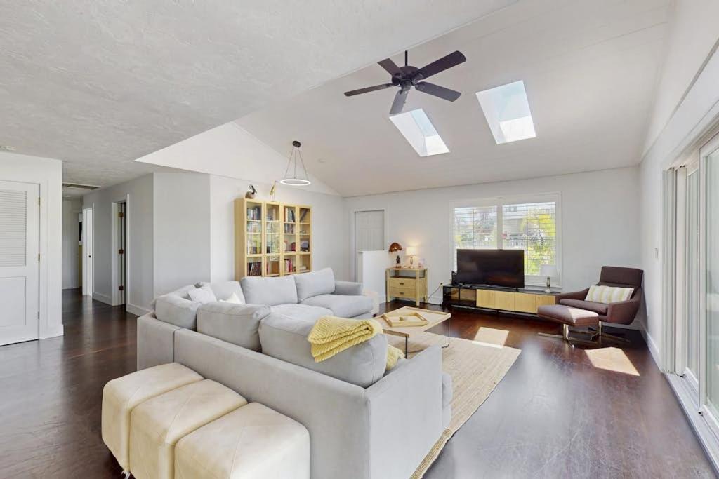 a living room with a white couch and a ceiling fan at Spring Oasis in Anna Maria