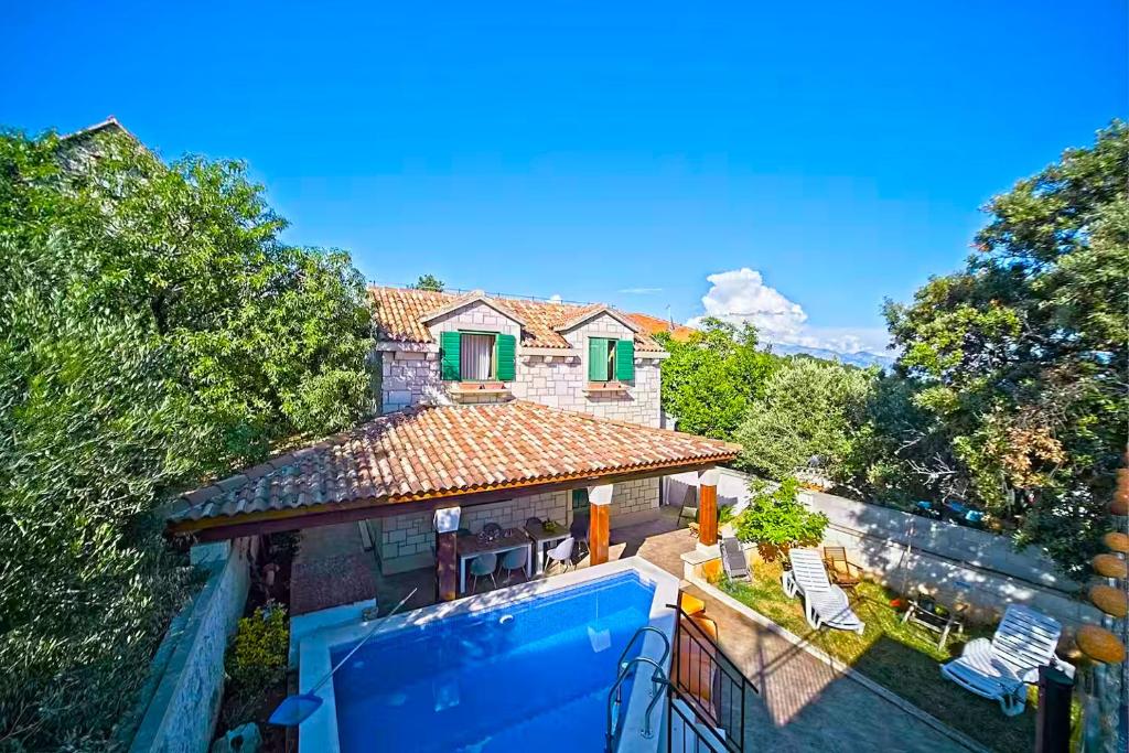 an aerial view of a house with a swimming pool at Villa Valentina with pool and close to beach in Selca