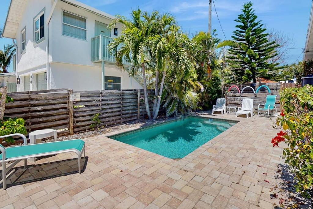 a swimming pool in the backyard of a house at Gertie's Lime House in Holmes Beach