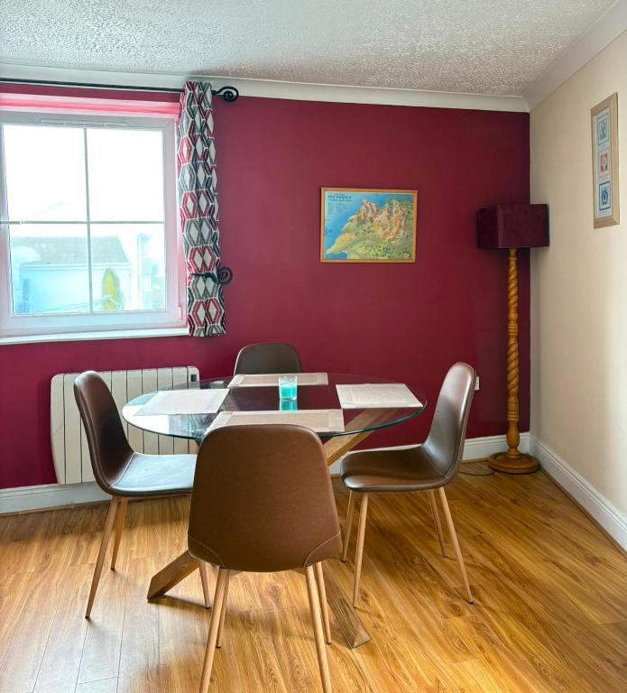 a dining room with a table and chairs at Avondale Apartment Lahinch in Lahinch