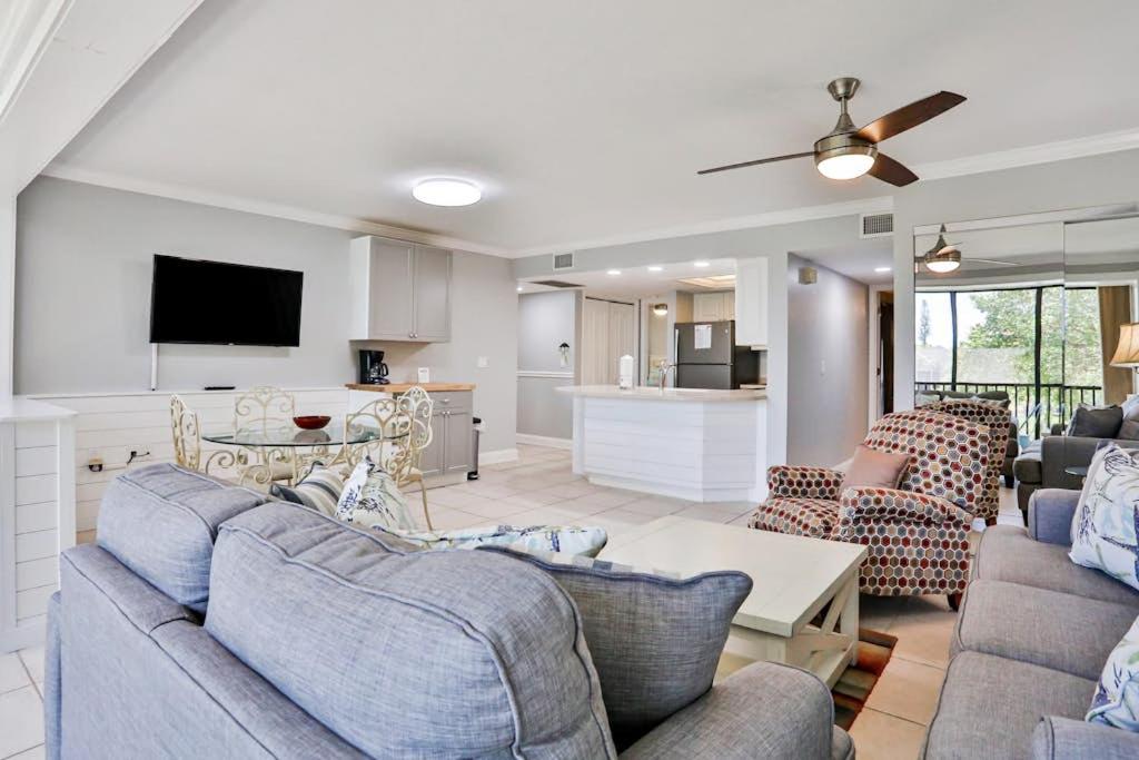a living room with two couches and a kitchen at Midnight Cove II 823 in Siesta Key