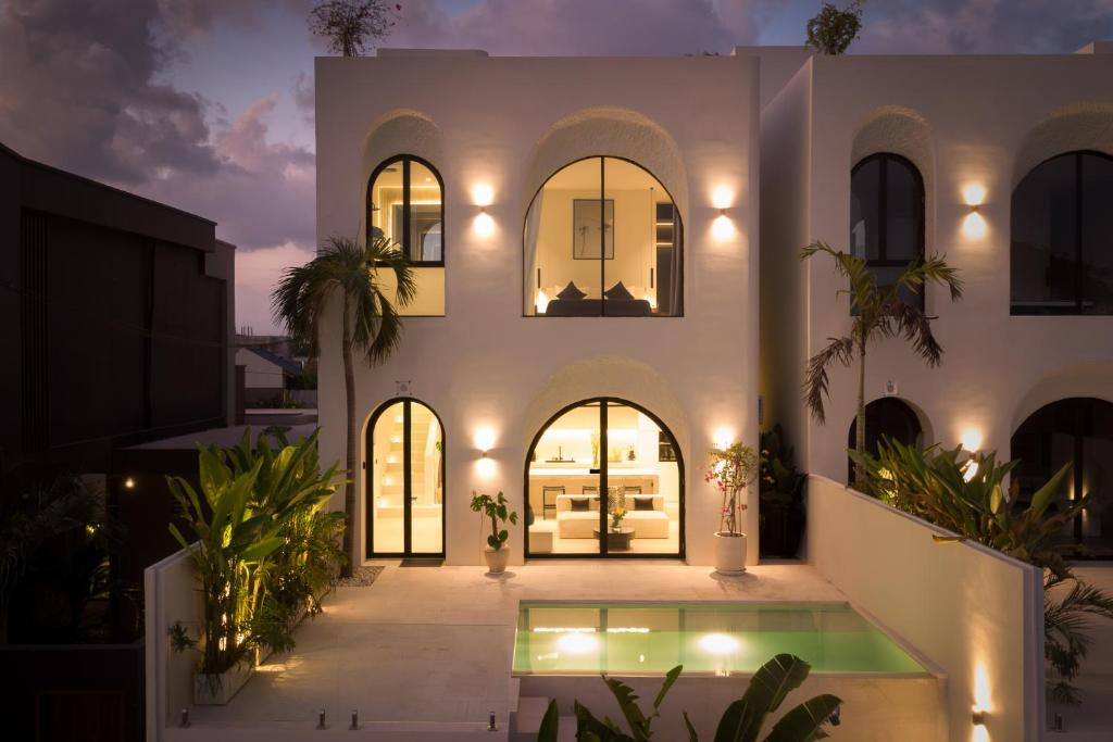 an exterior view of a house at night at Casa Infinity Villa 2 - Oasis 3BR & Ocean View by BaliSuperHost in Mengwi