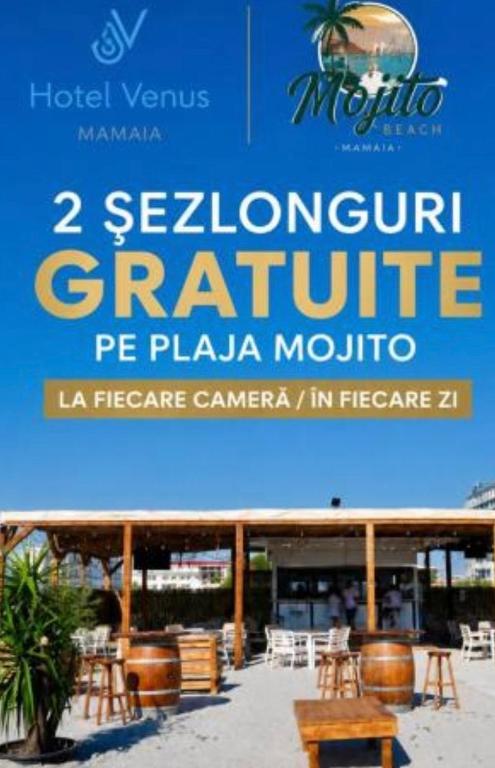 a sign for a restaurant with tables and chairs at Hotel Venus in Mamaia