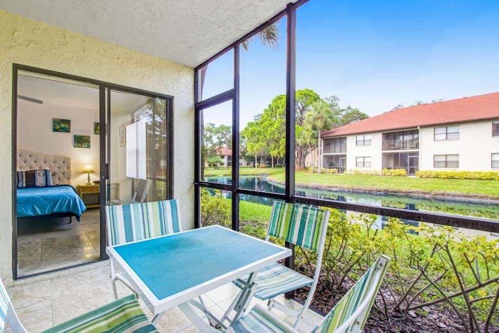a room with a table and chairs and a bedroom at Shorewalk 103 in Bradenton
