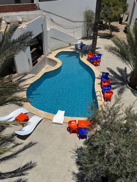 an overhead view of a swimming pool with lounge chairs and a swimming pool at Alaska Camp & Hotel in Dahab