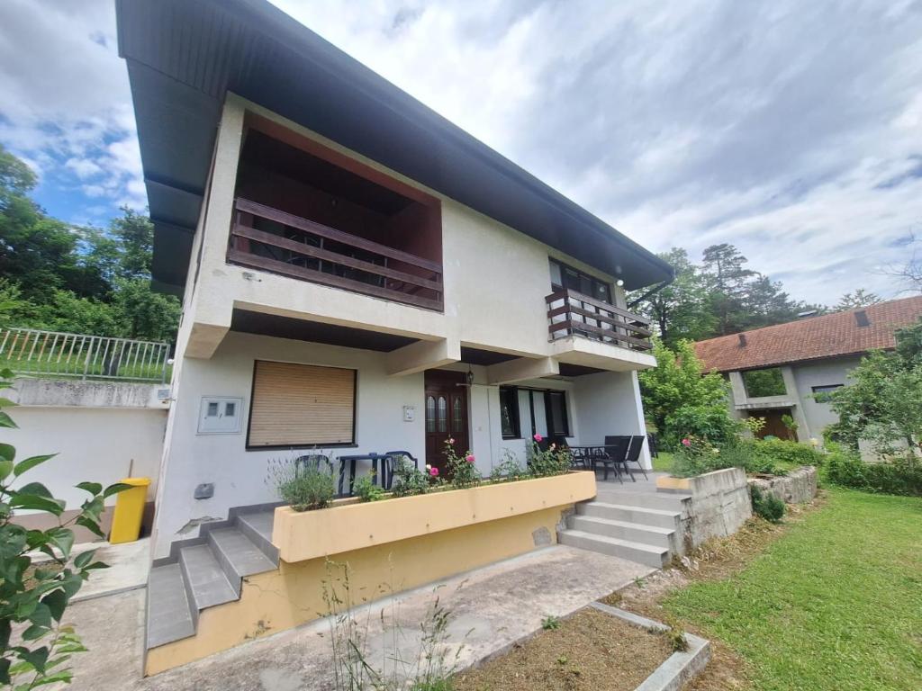 a white house with a black roof at Villa Tira in Jajce