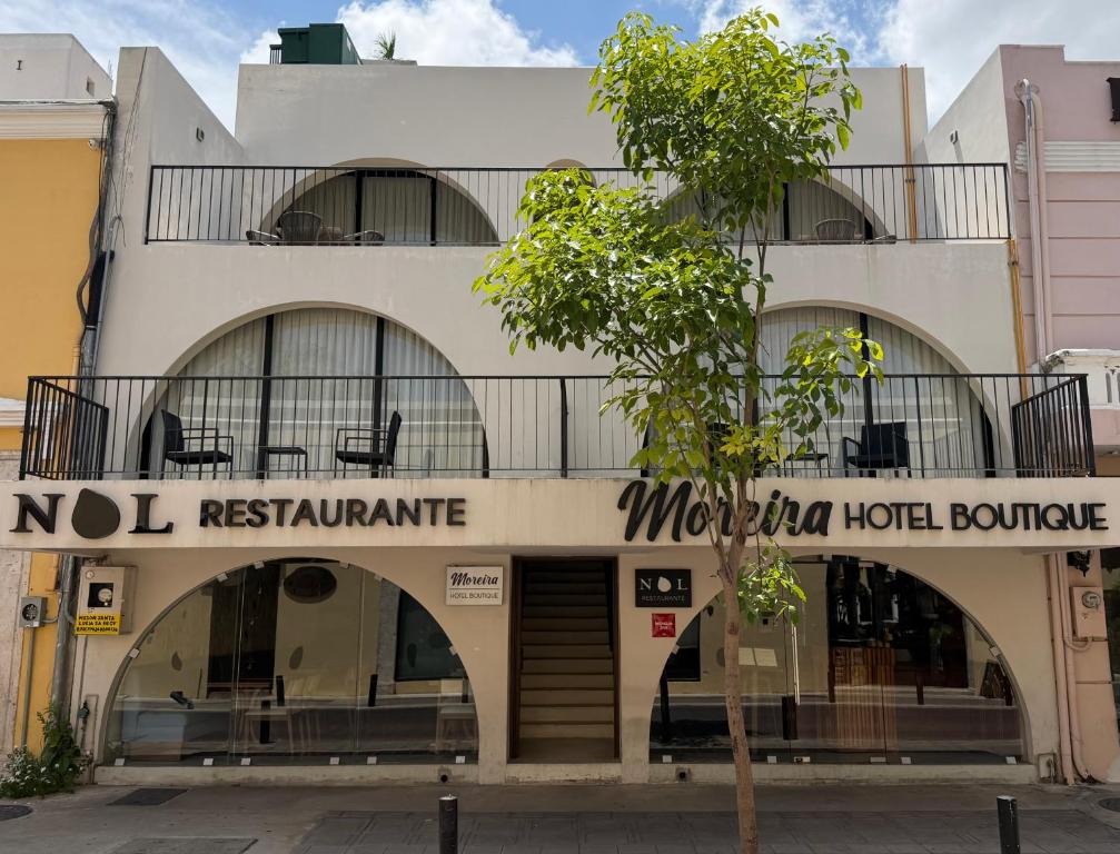a building with a sign for a hotel at Moreira Hotel Boutique in Mérida