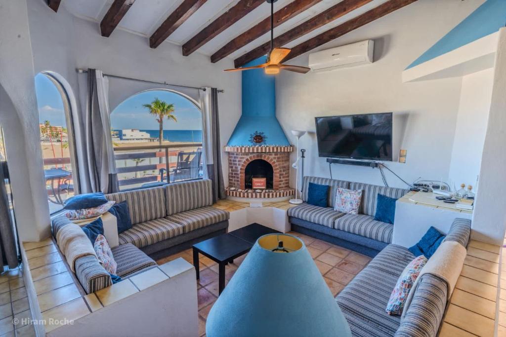 a living room with a couch and a fireplace at MarBrisas 3 Bed 2 Bath in Puerto Peñasco