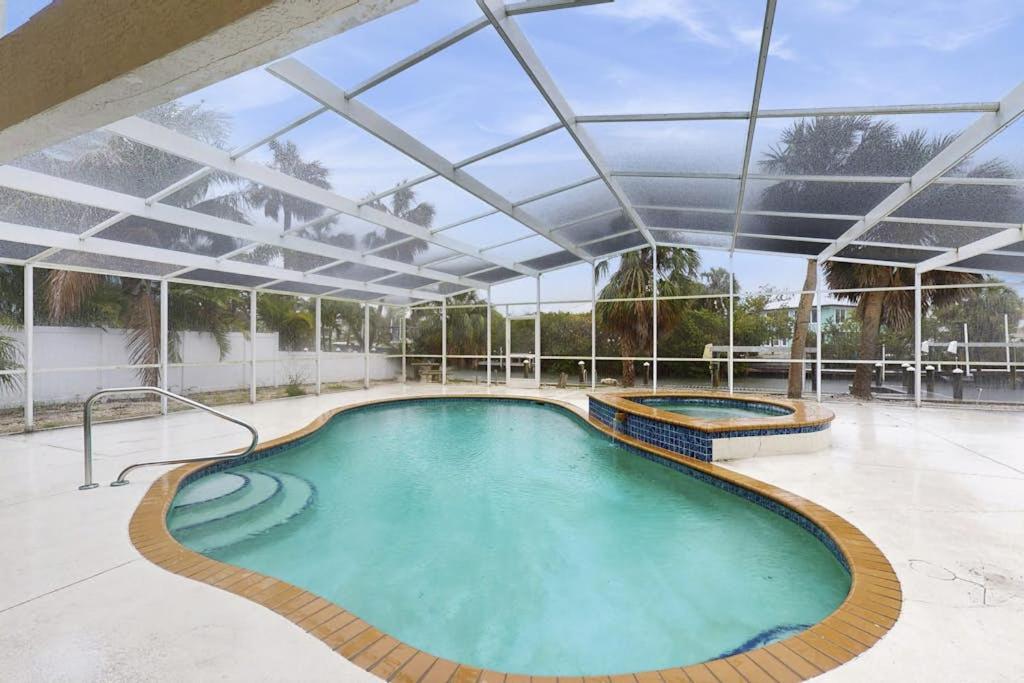 an indoor swimming pool with a large roof at Anna Maria's Finest in Anna Maria