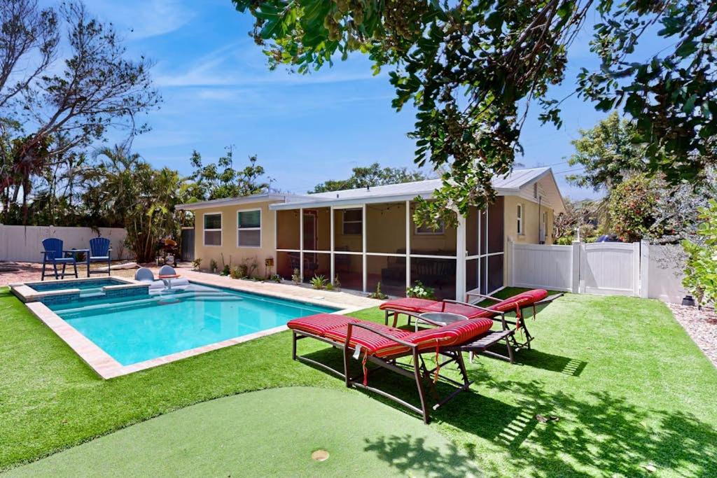 a backyard with a swimming pool and a house at Getaway on Gladiolus in Anna Maria